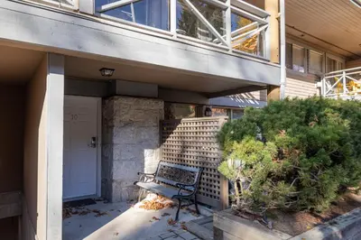 a bench sitting on the side of a building at 2BR in Valhalla, Whistler Village, Complex Hot Tub, Gas Fireplace, Parking, Gondola Shuttle in Whistler