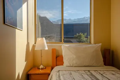 a bedroom with a bed and a window with a view at 2BR in Valhalla, Whistler Village, Complex Hot Tub, Gas Fireplace, Parking, Gondola Shuttle in Whistler