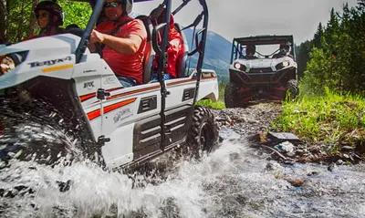 a group of people riding in an atv in the water at Ski In Ski Out Private Hot Tub in Panorama