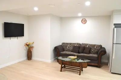 a living room with a couch and a table at Secondary Suite, Separate Entrance NW Calgary in Calgary