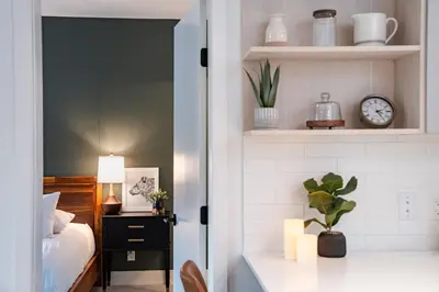 a bedroom with a bed and a clock on a shelf at Hemlock Hangout by Revelstoke Vacations in Revelstoke