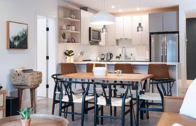a kitchen and dining room with a table and chairs at Hemlock Hangout by Revelstoke Vacations in Revelstoke