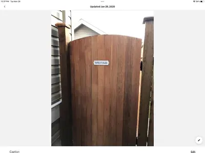 a wooden gate with a sign on it at Homelike & cozy suite in Langley