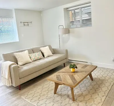 a living room with a couch and a coffee table at Homelike & cozy suite in Langley