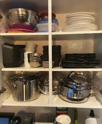 a kitchen pantry filled with pots and pans and dishes at 2 Full Beds, Free Parking Underground Heated, Rogers Place, 1 Bedroom Condo Downtown Central in Edmonton