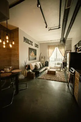 a large living room with a couch and a table at 2 Full Beds, Free Parking Underground Heated, Rogers Place, 1 Bedroom Condo Downtown Central in Edmonton
