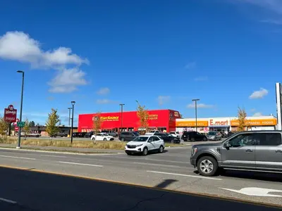 a group of cars driving down a road in a parking lot at Lovely comfy home private bath in central Calgary in Calgary