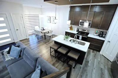 a living room and kitchen with a couch and a table at Three King Beds,Central A/C,Fireplace,Park,Disney+ in Edmonton