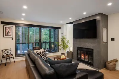 a living room with a couch and a fireplace at 2BR in The Gables, Prime Location, Steam Shower, Heated Flooring, Wood Burning Fireplace in Whistler
