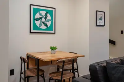 a dining room with a table and chairs at 2BR in The Gables, Prime Location, Steam Shower, Heated Flooring, Wood Burning Fireplace in Whistler