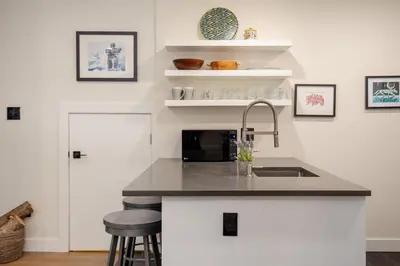 a kitchen with a sink and a microwave at 2BR in The Gables, Prime Location, Steam Shower, Heated Flooring, Wood Burning Fireplace in Whistler
