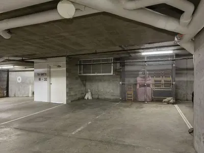 an empty parking garage with a person in a cage at 2BR in The Gables, Prime Location, Steam Shower, Heated Flooring, Wood Burning Fireplace in Whistler
