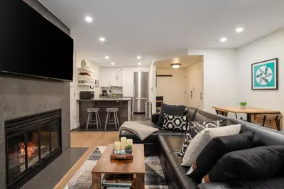 a living room with a couch and a fireplace at 2BR in The Gables, Prime Location, Steam Shower, Heated Flooring, Wood Burning Fireplace in Whistler