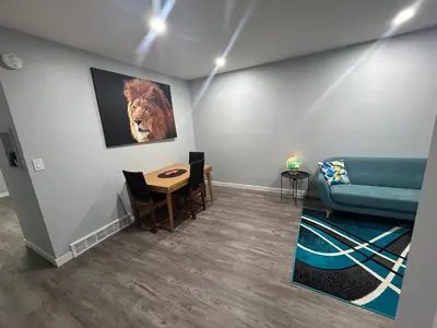 a living room with a couch and a table at Cute Highland Park(Upper-A-Unit) in Calgary