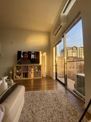 a living room with a couch and a large window at Laid Back In Langford in Langford