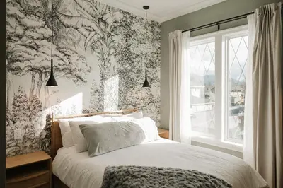 a bedroom with a bed with a floral wallpaper at Hotel Morado in Chilliwack