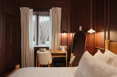 a bedroom with a table and a bed and a window at Hotel Morado in Chilliwack