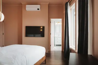 a bedroom with a bed and a tv on the wall at Hotel Morado in Chilliwack