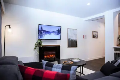 a living room with a couch and a fire place at Absolutely Revy - Ground Level Condo in Revelstoke in Revelstoke