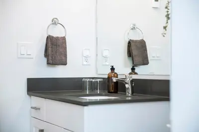 a kitchen with a sink and a mirror at Absolutely Revy - Ground Level Condo in Revelstoke in Revelstoke