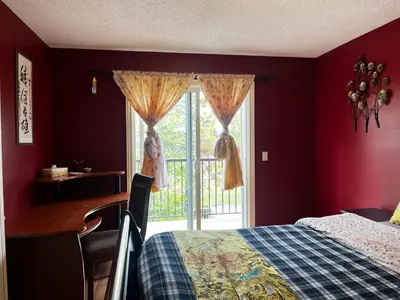 a bedroom with a bed and a desk and a window at Beddington masteroom close airport! in Calgary