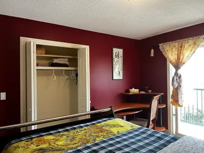 a bedroom with a bed and a table and a window at Beddington masteroom close airport! in Calgary