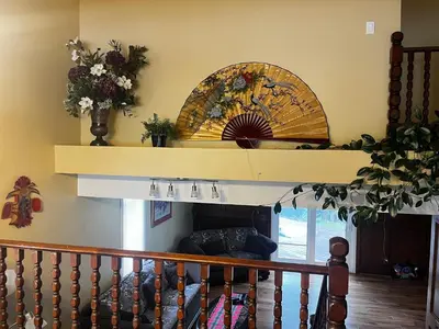a living room with a fireplace and a shelf at Beddington masteroom close airport! in Calgary