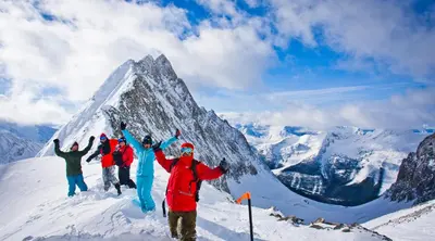 a group of people standing on top of a mountain at 2 Bedroom and Wall Bed Mountain Getaway Ski In Ski Out Condo with Hot Pools Sleeps 8 in Panorama