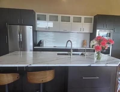 a kitchen with a sink and a counter with flowers on it at Five Star-Amazing views and Hot Tub in Crescent Valley