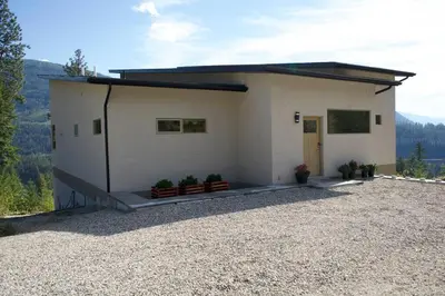 a large white building with plants in front of it at Five Star-Amazing views and Hot Tub in Crescent Valley