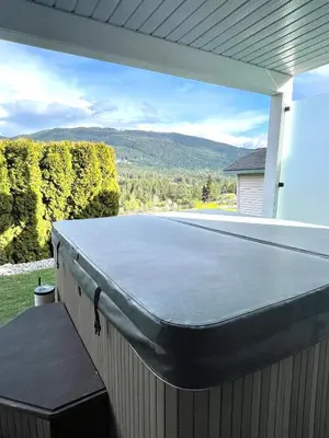 a ping pong table on the back of a house at Relaxing 3 bedroom suite, near Silver Star Resort in Vernon