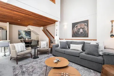 a living room with a couch and a table at Foxglove by Outpost Whistler in Whistler