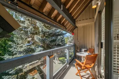 a balcony with a table and chairs on it at Foxglove by Outpost Whistler in Whistler