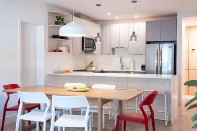 a kitchen with a wooden table and chairs at Hygge Haus by Revelstoke Vacations in Revelstoke