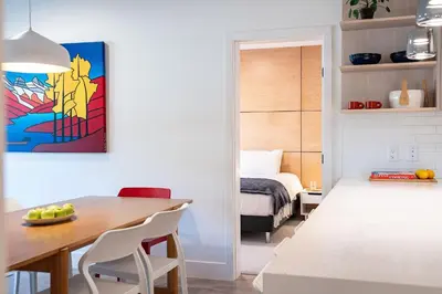 a dining room with a table and a bedroom at Hygge Haus by Revelstoke Vacations in Revelstoke