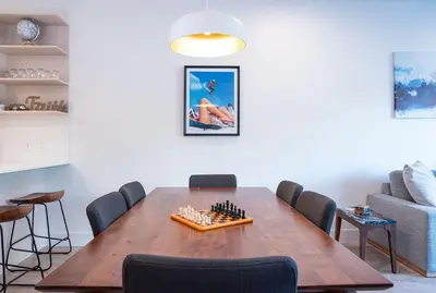 a dining room with a chess board on a wooden table at Mountainside Revival by Revelstoke Vacations in Revelstoke