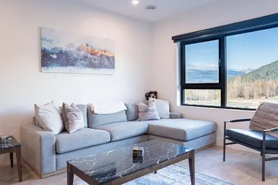 a living room with a couch and a table at Mountainside Revival by Revelstoke Vacations in Revelstoke