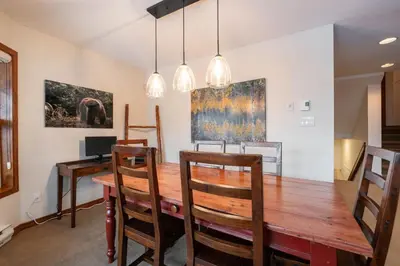 a dining room with a wooden table and chairs at Blackcomb Greens by Outpost Whistler in Whistler