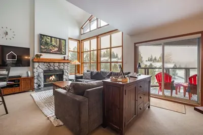 a living room with a couch and a fireplace at Blackcomb Greens by Outpost Whistler in Whistler