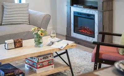 a living room with a couch and a fireplace at Revytalise - Cozy 3 Bedroom Condo in Revelstoke
