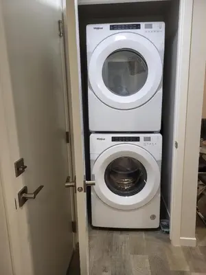 a washing machine and a washer and dryer in a room at Modern 2 Bed Urban Retreat in Calgary