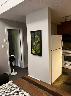 a kitchen with a white refrigerator in a room at The Eden Whistler - Luxury 2 BDRM Ski in / Ski out in Whistler