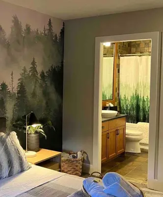 a bedroom with a bathroom with a bed and a sink at The Eden Whistler - Luxury 2 BDRM Ski in / Ski out in Whistler
