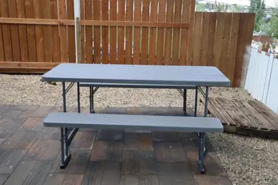 a blue picnic table sitting on a patio at CenterStreet-Cozy 2bedroomSuite in Calgary