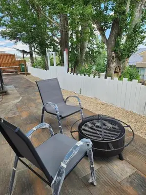 two chairs and a fire pit on a patio at CenterStreet-Cozy 2bedroomSuite in Calgary