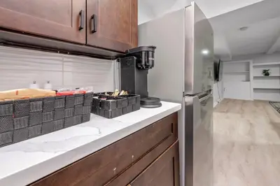 a kitchen with a counter top with a stove at CenterStreet-Cozy 2bedroomSuite in Calgary
