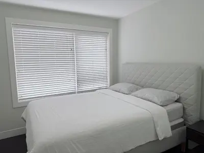 a bedroom with a white bed and a window at Spacious Home in Richmond in Richmond