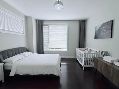 a bedroom with a bed and a crib in it at Spacious Home in Richmond in Richmond
