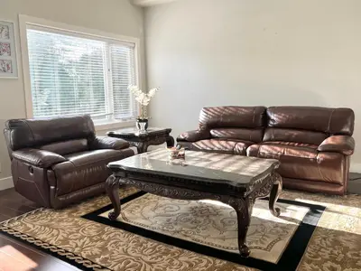 a living room with a leather couch and a coffee table at Spacious Home in Richmond in Richmond
