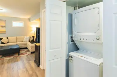 a kitchen with a washer and dryer and a living room at NN - The Mack - Crestview 1-bed 1-bath in Whitehorse